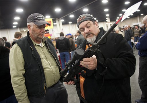 Gun owners discuss a potential sale of an AR-15, one of the most popular and controversial weapons, during the 2013 Rocky Mountain Gun Show at the South Towne Expo Center in Sandy, Utah, in January. This week a bill to close the private-sale exception to the instant background check law barely made it out of the Judiciary Committee, with all Republicans in favor of keeping the gun show loophole wide open.