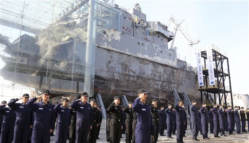 South Korean navy sailors pay tribune to mark the third anniversary of the sinking of South Korean naval ship "Cheonan" in front of the wreckage of the vessel at the Second Fleet Command of Navy in Pyeongtaek, south of Seoul, on Tuesday.