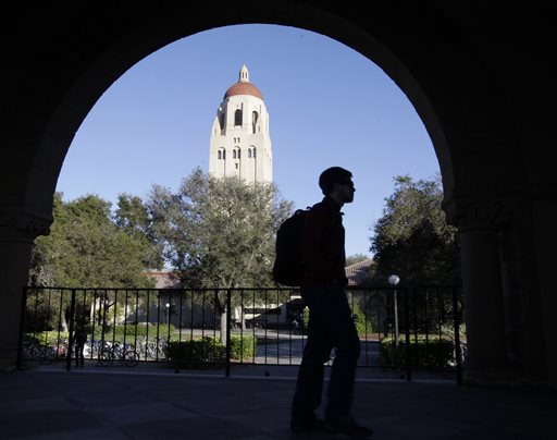 A Stanford University student walks in front of Hoover Tower on campus in Palo Alto, Calif., in this 2012 photo, Congressional inaction could end up costing college students an extra $5,000 on their new loans.