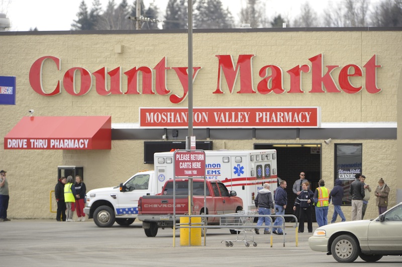 State police work the scene of a shooting Thursday, March 28, 2013, at the County Market grocery store on the outskirts of Philipsburg, Pa. Pennsylvania State Police say the gunman in a supermarket shooting is a retired state trooper, and the woman he shot before killing himself had been his wife. State police spokeswoman Maria Finn said Thursday troopers were working to notify their closest victims, holding up public identification of the two. (AP Photo/Centre Daily Times, Nabil K Mark)