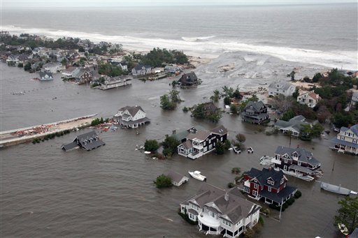 This Oct. 30, 2012, file photo shows an aerial view of the damage to the shoreline and the houses in Mantoloking, N.J., the day after Superstorm Sandy. A rising number of homes damaged by Sandy are hitting the market – ranging from 10 percent off pre-storm prices for upscale homes in New York's Long Island and the Jersey Shore to up to 60 percent off modest bungalows in Staten Island and Queens – but it's very much a game of buyer beware.