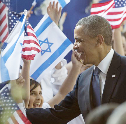 President Barack Obama is greeted by children waving Israeli and American flags as he arrives at the residence of Israeli President Shimon Peres on Wednesday in Jerusalem.