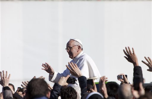 Pope Francis waves to crowds as he arrives to his inauguration Mass in St. Peter's Square at the Vatican on Tuesday. Pope Francis urged world leaders and ordinary people to protect the environment, the weakest and the poorest.