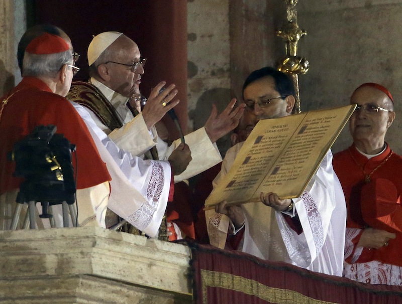 Pope Francis speaks from the central balcony of St. Peter's Basilica at the Vatican, Wednesday, March 13, 2013. Cardinal Jorge Bergoglio who chose the name of Francis, is the 266th pontiff of the Roman Catholic Church. (AP Photo/Luca Bruno)