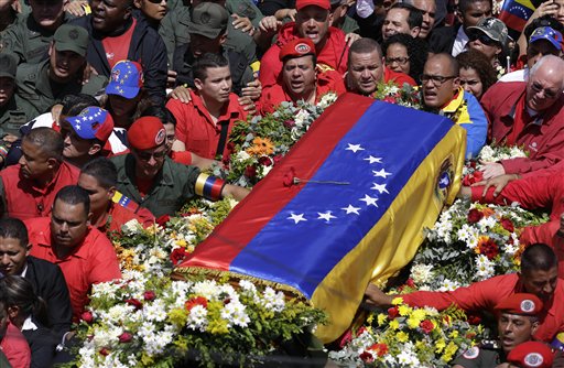 The flag-draped coffin containing the body of Venezuela's late The coffin of President Hugo Chavez is taken from the hospital where he died to a military academy where it will remain until his funeral in Caracas on Friday.
