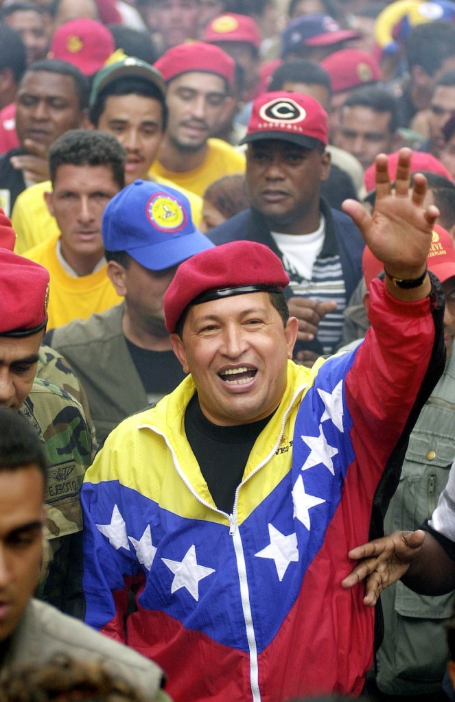 In this Jan. 23, 2002 file photo, Venezuela's President Hugo Chavez waves to supporters during a government march commemorating the anniversary of Venezuelan democracy in Caracas, Venezuela. Venezuela's Vice President Nicolas Maduro announced on Tuesday, March 5, 2013 that Chavez has died. Chavez, 58, was first diagnosed with cancer in June 2011. (AP Photo/Fernando Llano, File)
