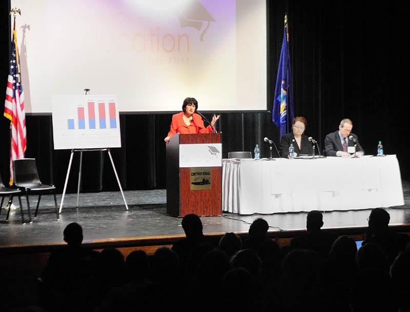 Jeanne Allen, president of the Center for Education Reform, standing right, speaks during Governor's Conference on Education: Putting Students First on Friday at Cony High School in Augusta.