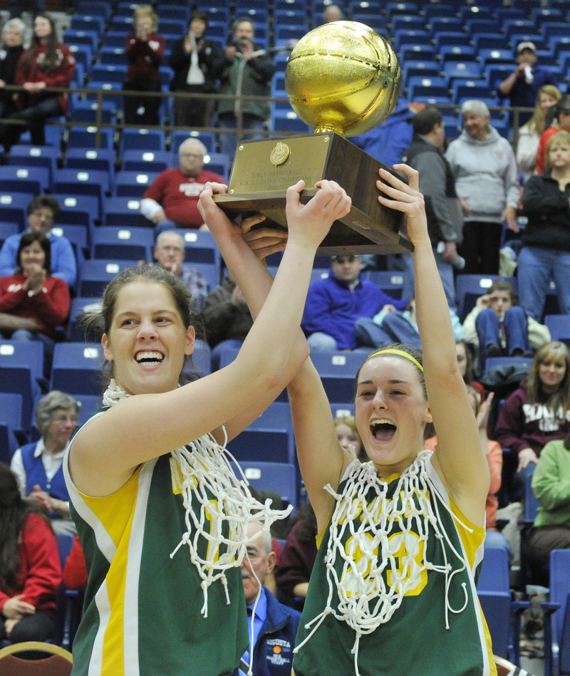 McAuley captains Molly Mack, left, and Allie Clement hold up the Gold Ball after their team won its third straight Class A state championship with a 60-45 victory over Bangor at the Augusta Civic Center.