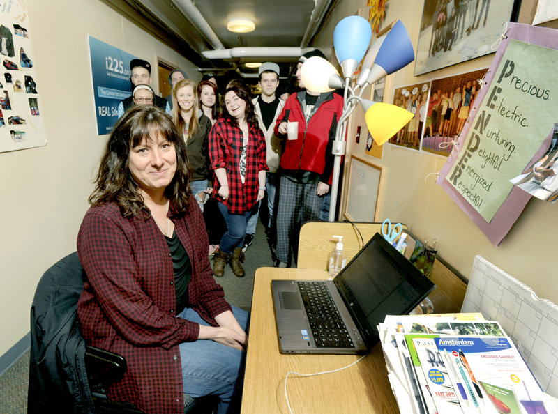 The REAL school principal Pender Makin was named the Maine Principal of the Year. Makin is seen here Thurs. Feb. 28, 2013 with some of her students at her hall desk at the school's Falmouth campus.