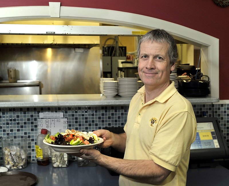 Philip Ryle prepares to serve a Cobb salad to a customer at Bernie’s – soon to be Madden’s.