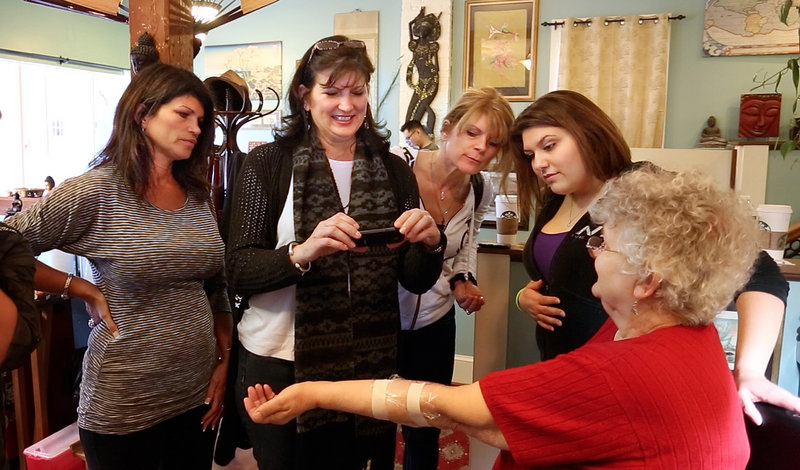 At right, Barbara Roggio of Thomaston shows off the tattoo she got Thursday, Feb. 28, 2013 at Tsunami Tattoo in Portland in honor of her late daughter Robyn Hesseltine. Looking on from left is Sharon Boucher of Acton, Mass., Barbara Osmond of Rock Hill, S.C., Cheryl Spataro of California and Jennifer Osmond of Rock Hill, S.C., who all also received tattoos.