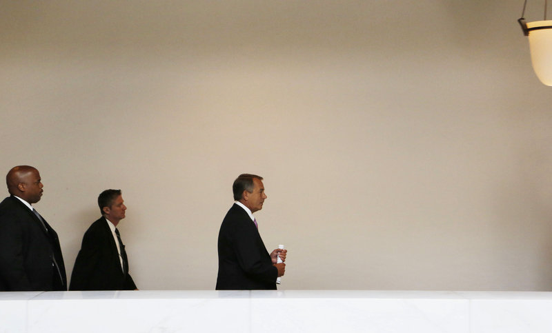 Speaker of the House John Boehner, right, walks from a news conference on Capitol Hill Thursday. Boehner, a Republican, was to meet with President Obama and other leaders Friday on the sequester issue, but no one seriously expects action.