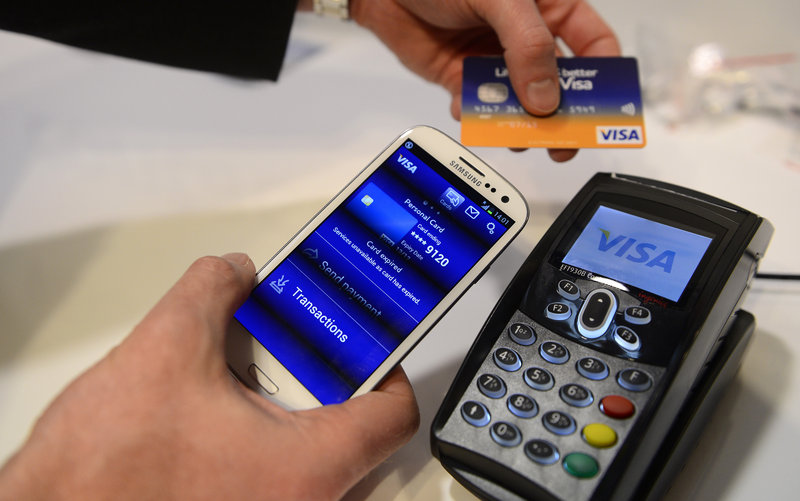 A Visa cellphone payment system is shown at a trade show this week in Barcelona, Spain. Visa has a deal with Samsung to take charge of the “secure element” in its new cellphone.