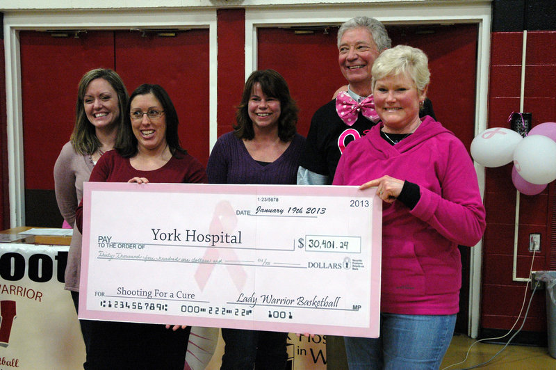 York Hospital Breast Care Team members, from left, Lisa Plourde, Amanda Demetri Lewis, Joann Paquette, York Hospital President Jud Knox and Kathy Bry accept an honorary check representing a gift raised by Wells basketball players.
