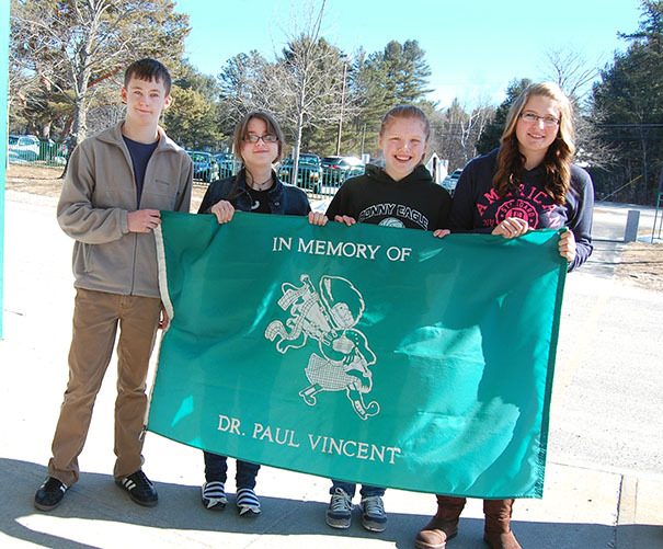 Ronahn Clarke, Sydney Atkinson, Jennifer Turner and Kasey Grant hold Bonny Eagle Middle School’s Honor Flag, which was raised to salute their writing achievements in the 2013 Scholastic Art & Writing Awards.