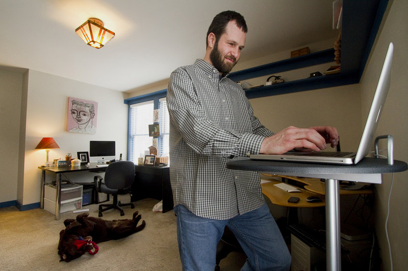 Mike MacDonald, a software engineer, works at home in Cape Elizabeth on Friday. A telecommuter since 2005 for a company based in California, MacDonald acknowledges, “sometimes there’s no substitute for hashing things out together on a whiteboard and solving a problem.”