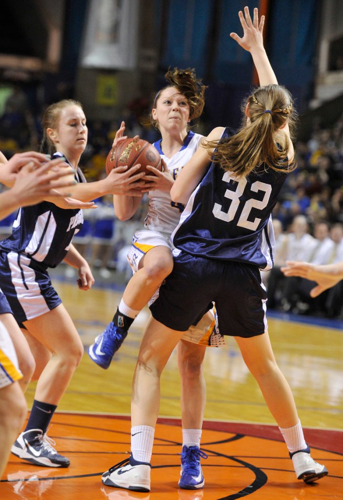 Sydney Hancock of Lake Region finds herself out of room Friday night while driving the lane against Hannah Graham of Presque Isle during Presque Isle’s 51-44 victory in the Class B state championship game at the Cumberland County Civic Center.