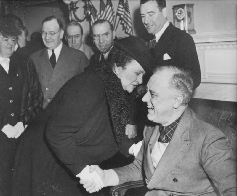 Frances Perkins, the first woman appointed to a U.S. Cabinet post,greets President Franklin Roosevelt in this 1940s photo.