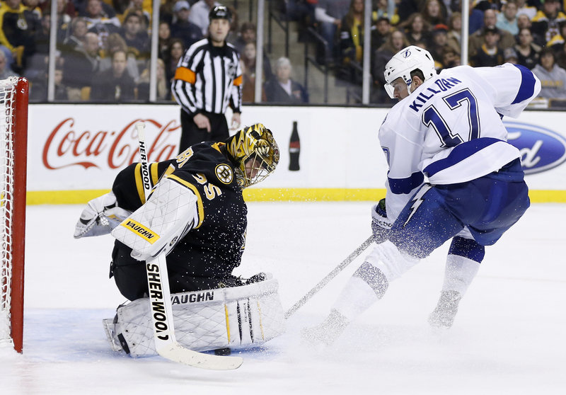 Boston goaltender Anton Khudobin drops to the ice to frustrate Alex Killorn’s scoring bid during third-period action of Saturday’s Bruins-Tampa Bay Lightning game in Boston, won by the Bruins 3-2.