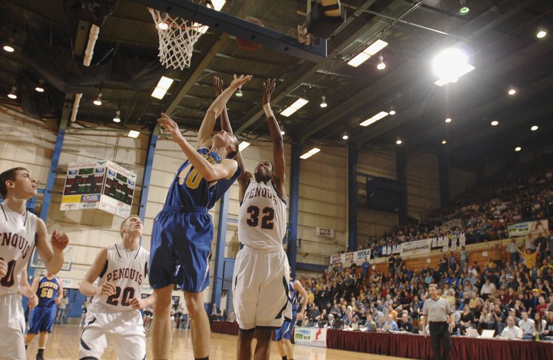 John Hepburn, left, of Boothbay, and Isaiah Bess of Penquis go up for a rebound Saturday night during the last basketball game at the Bangor Auditorium – the Class C boys’ state final. Bess scored 27 points to lead Penquis to a 61-54 victory.