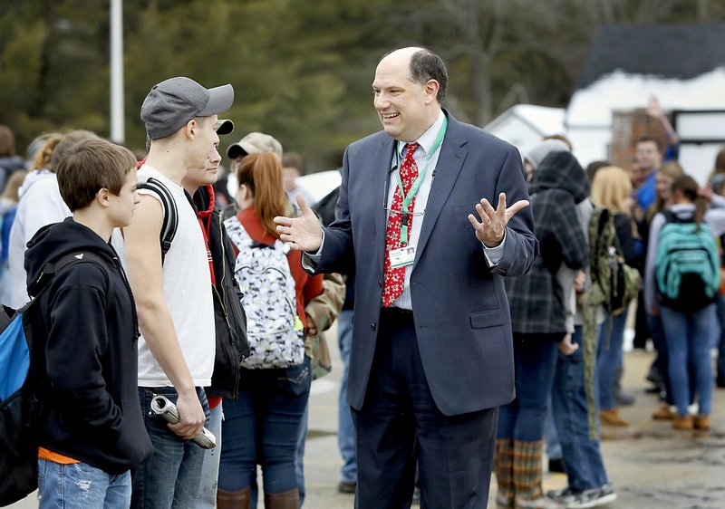 Massabesic High School Principal Christian Elkington visits with students waiting for a bus at the end of the school day in Waterboro on Friday. “We’re being told, even if we’re making gains, they’re not good enough,” Elkington said.