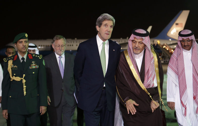 Secretary of State John Kerry walks with Saudi Foreign Minister Prince Saud al-Faisal as he arrives Sunday in Riyadh, Saudi Arabia, on the seventh leg of his first official overseas trip.