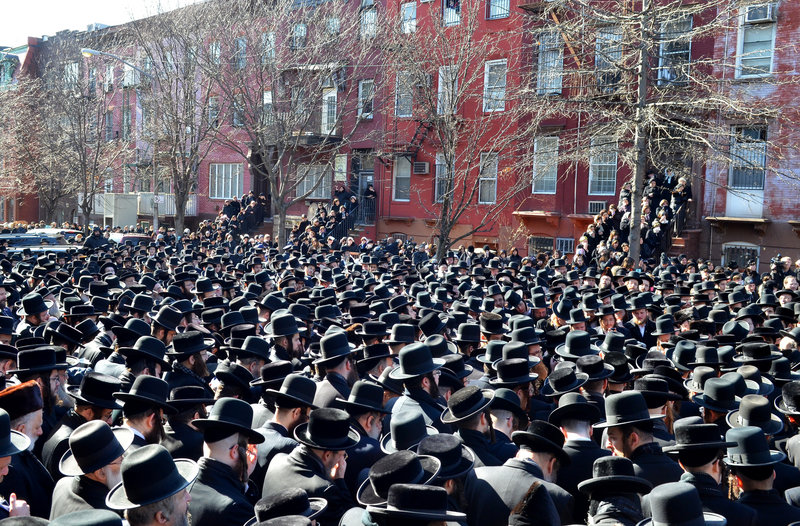 Orthodox Jewish mourners gather outside the Congregation Yetev Lev D’Satmar synagogue in Brooklyn’s Williamsburg neighborhood Sunday for the funeral of two expectant parents who were killed in a car accident earlier in the day in New York. The baby of Nachman and Raizy Glauber was delivered prematurely, but died around 5:30 a.m. Monday.