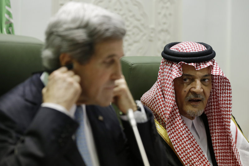 Secretary of State John Kerry adjusts his translation headset as Saudi Foreign Minister Prince Saud al-Faisal speaks during a news conference in Riyadh, Saudi Arabia, on Monday.