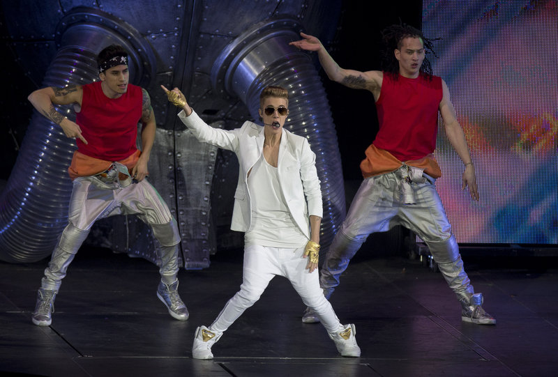 Justin Bieber performs at the 02 Arena in London on Monday. Concertgoers said he appeared on stage almost two hours late.