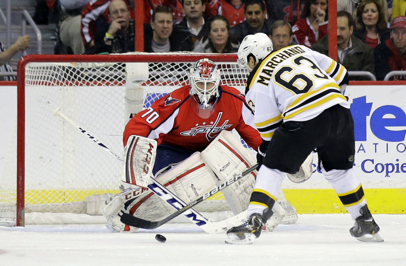 Boston’s Brad Marchand scores on a penalty shot against Washington goaltender Braden Holtby during first-period action of Tuesday’s game in Washington, won in overtime by the Capitals.