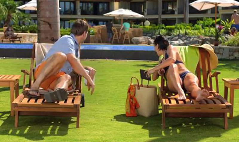 A Kindle Paperwhite commercial features a vacationing man and woman both waiting for their husbands, shown in the background at a bar. Gay people are increasingly part of screen and print advertising.