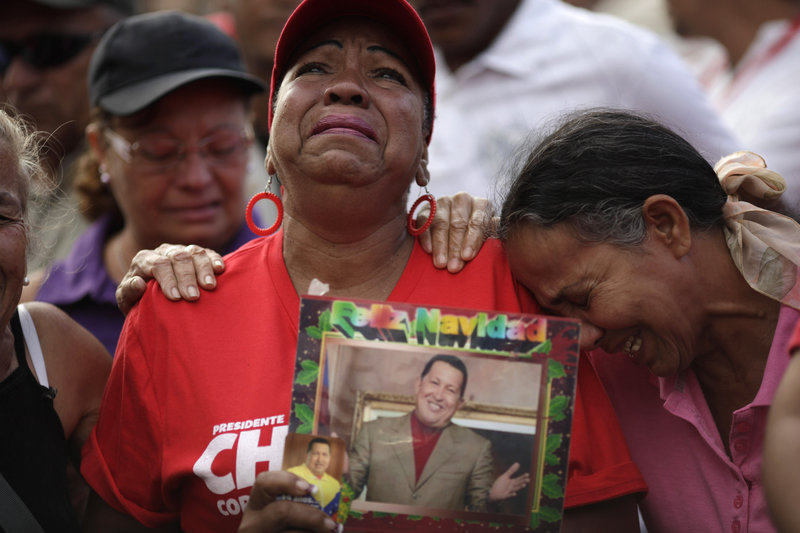 Supporters of Venezuela’s late President Hugo Chavez mourn Wednesday outside the military hospital where Chavez died of cancer at age 58 Tuesday in Caracas. World leaders will attend his elaborate funeral Friday.