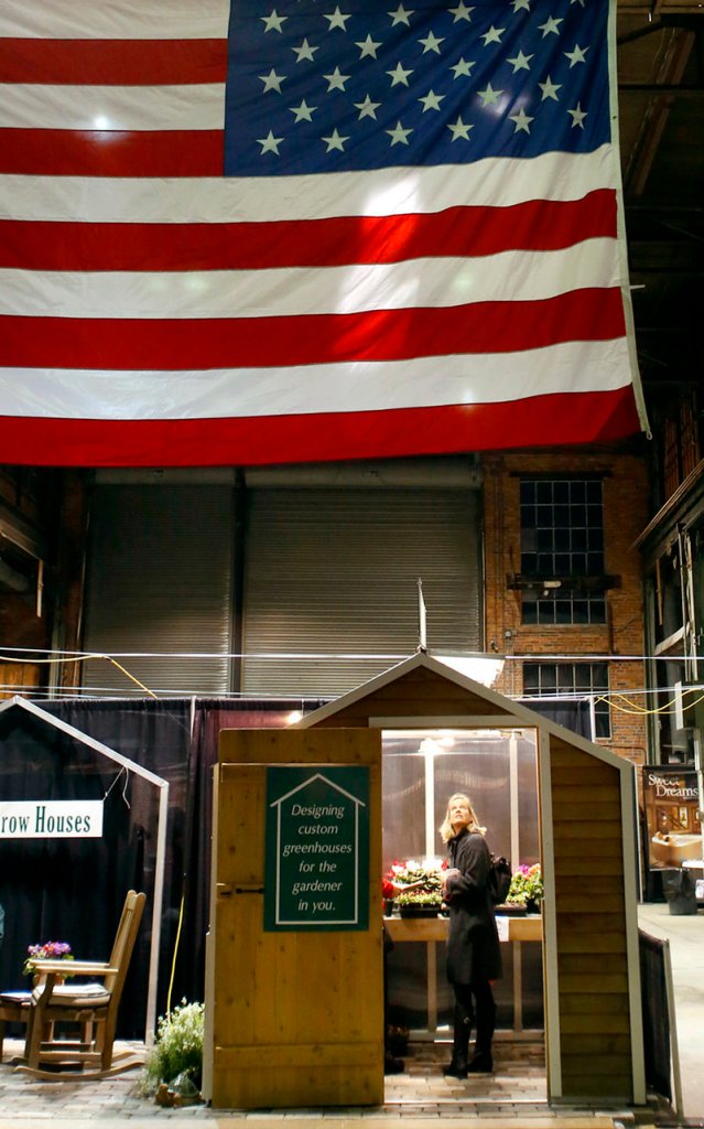 Betsey Andersen of Falmouth looks at a custom greenhouse at the Ken's Grow Houses display during the opening night of the Portland Flower Show at the Portland Company Complex in Portland on March 6, 2013.