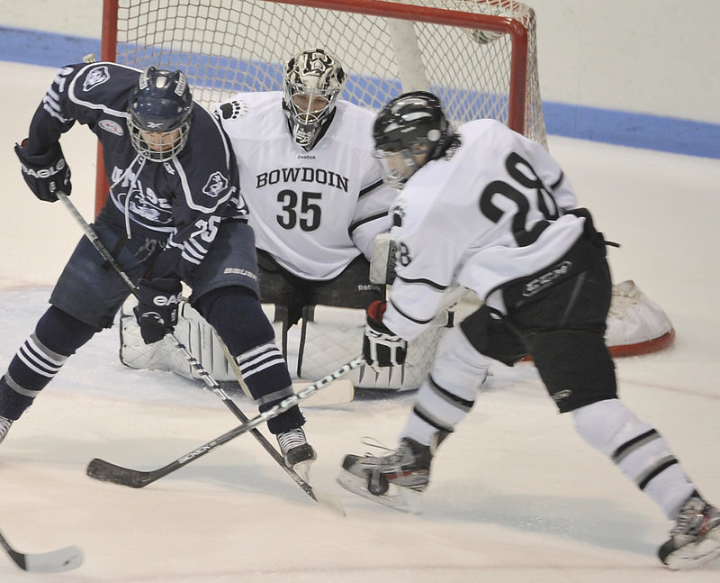 Bowdoin’s Timothy McGarry battles with Shaun Walters of UMass-Dartmouth in front of goalie Steve Messina Wednesday in an NCAA Division III playoff game.