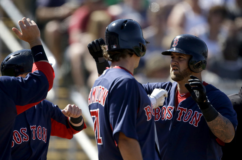 Mike Napoli, right, is welcomed by teammates Thursday after hitting a three-run homer for the Boston Red Sox in a 12-5 victory against the Minnesota Twins.