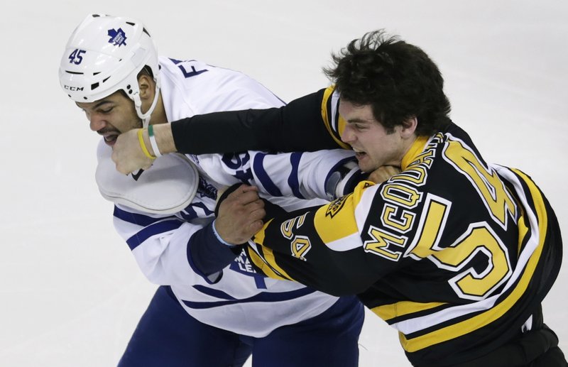 Although helmet-less, Boston defenseman Adam McQuaid manages to graze Maple Leaf Mark Fraser’s jaw with a right cross during an early fight in Thursday’s 4-2 victory in Boston.