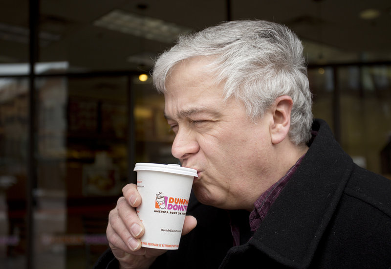 Ernie Mills of Old Orchard Beach sips coffee from his paper Dunkin’ Donuts cup Friday. Mills said he prefers paper over Styrofoam because of the feel of the cup.