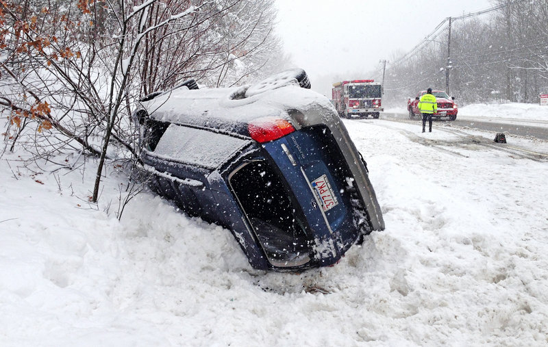 A Subaru Outback is rolled over on Route 20 in Charlton, Mass., near the Sturbridge line, blocking part of the westbound lane Friday.