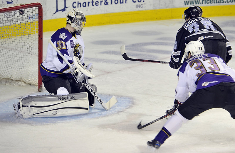 Darian Dziurzynski flips the puck over the shoulder of Manchester Monarchs goalie Martin Jones and into the top corner of the net for a first-period goal that gave the Pirates a 2-0 lead. Portland led 3-0 after one period but lost 4-3 in overtime.