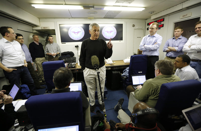 Defense Secretary Chuck Hagel speaks to the traveling press aboard his military aircraft, en route to Afghanistan on Friday.