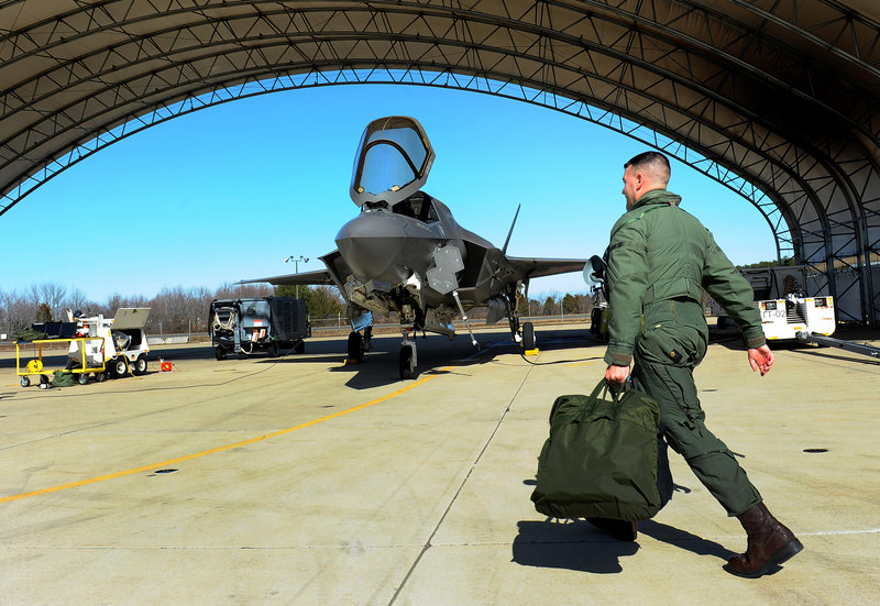 Marine test pilot Maj. Richard Rusnok prepares for a flight in an F-35 at Naval Air Station Patuxent River in Maryland. The plane’s design and initial production cost $84 billion.