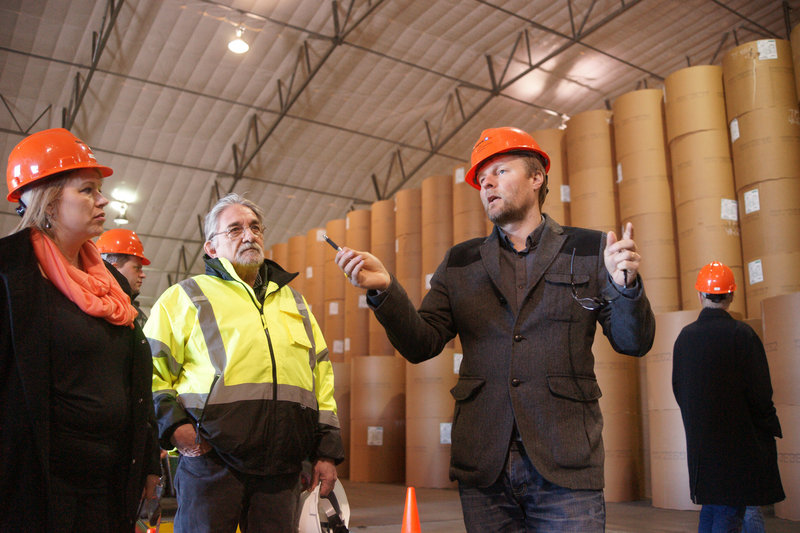Larus Isfeld, a senior manager at Eimskip, talks about storing bulk freight, such as water from Iceland, in Sprague's climate-controlled warehouse at Merrill's Marine Terminal in Portland. Listening are Joanne Gibbons, Eimskip's freight forwarding manager in St. John's, Newfoundland, and Arnand Demers, director of forest products/materials handling for Sprague.
