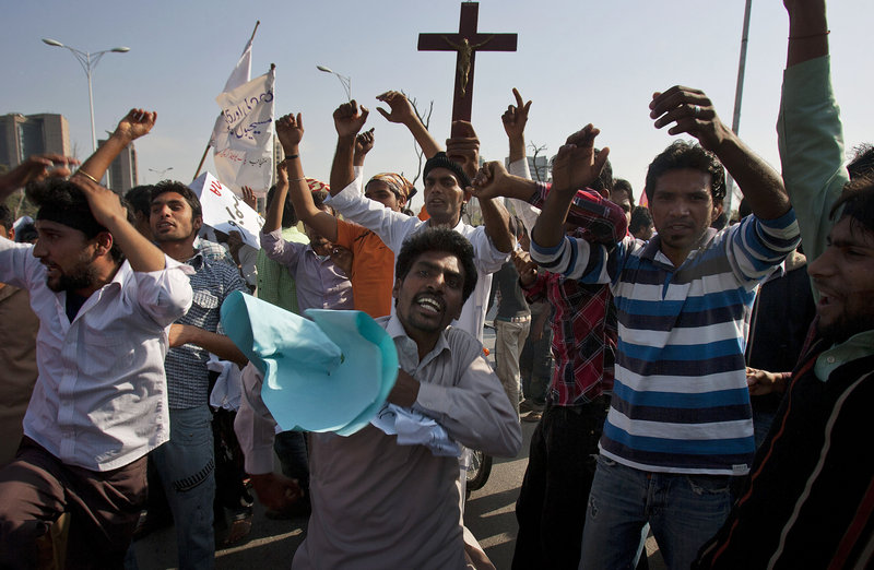 Pakistani Christians in Islamabad chant slogans at a protest Sunday demanding that the government rebuild their homes, which were burned following an alleged blasphemy incident.