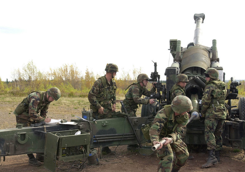 In this October 2001 file photo, Maine Army National Guardsmen load a round into a Howitzer gun on Saturday during training at the Canadian Forces Base Gagetown in New Brunswick, Canada. The guardsmen belonged to the Alpha Battery of the 1st Battalion, 152 Field Artillery.