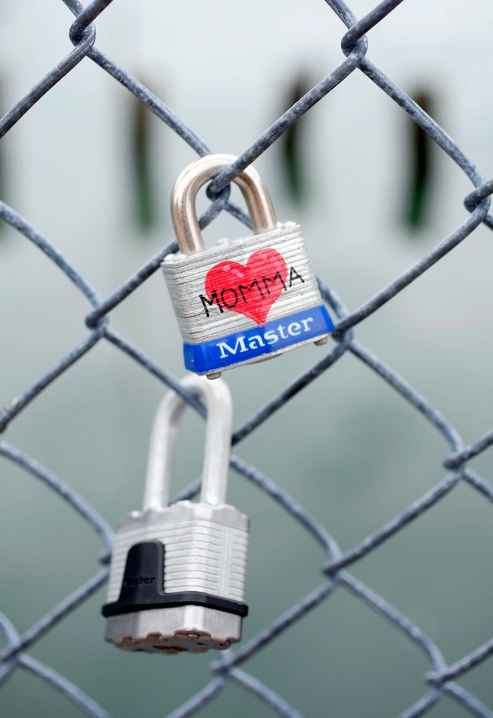 A padlock dedicated to “Momma” joins the dozens of other locks on the Commercial Street fence.