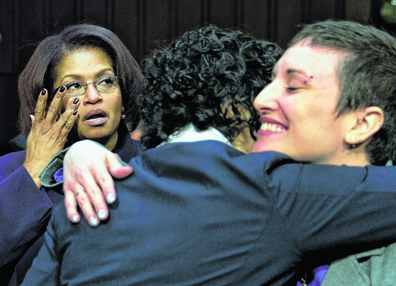 Former Army Spc. BriGette McCoy, left, former Army Sgt. Rebekah Havrilla, right, and former Marine Anu Bhagwati react after testifying about sexual assault in the military.