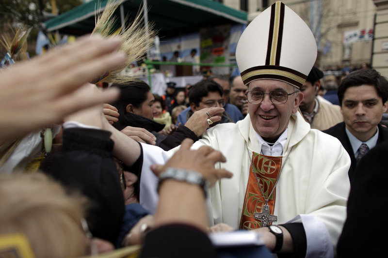 Then-Cardinal Jorge Bergoglio, now Pope Francis, greets crowds outside San Cayetano church in Buenos Aires in 2009. The new pope is a staunch conservative and devout Jesuit.