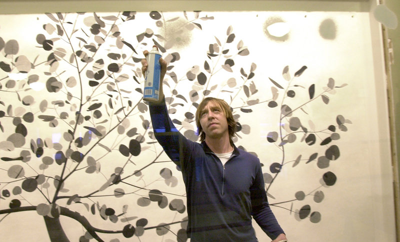 In this January 2005 file photo, artist Joe Kievitt does some touch up work on his large artwork hanging at Kennebunk Elementary School. Kievitt is among the artists chosen for the 2013 Portland Museum of Art Biennial.