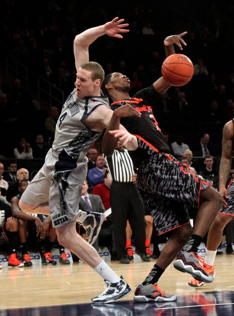 Georgetown’s Nate Lubick, left, and Cincinnati’s Titus Rubles get locked up as they battle for a rebound during the Hoya’s 62-43 win in a Big East quarterfinal game at New York on Thursday.