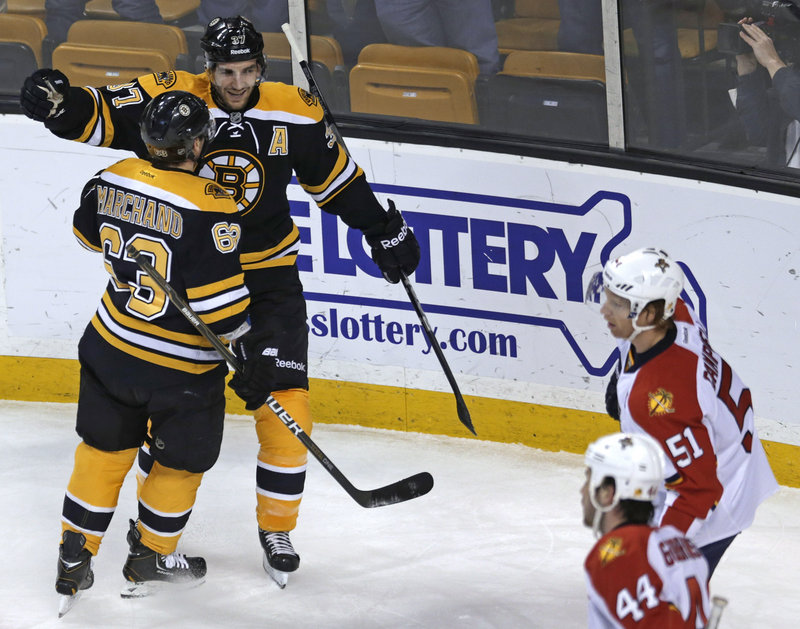 Boston center Patrice Bergeron is congratulated by linemate Brad Marchand, 63, after a first-period goal against Florida in Thursday’s game, won by the Bruins.